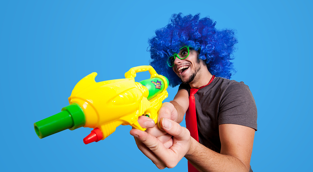 Funny guy with blue wig and water gun